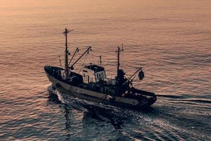 EU fishing boat at sunset
